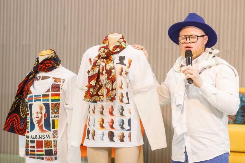 Printed long-sleeve tops on display at a festival.